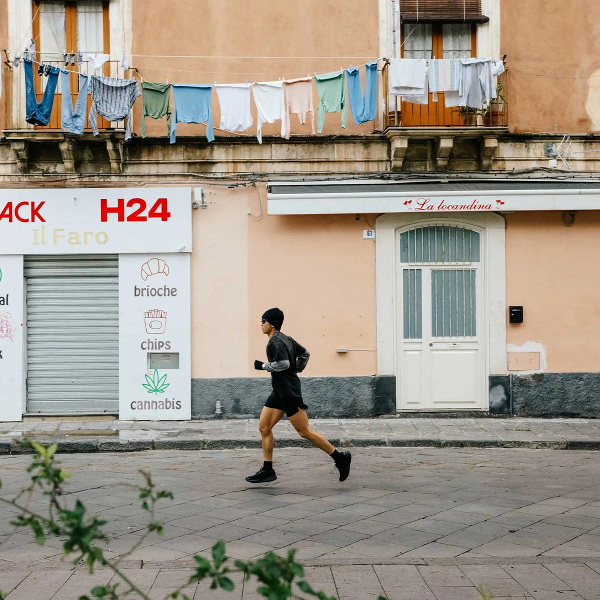 Rei running through a street in Sicily